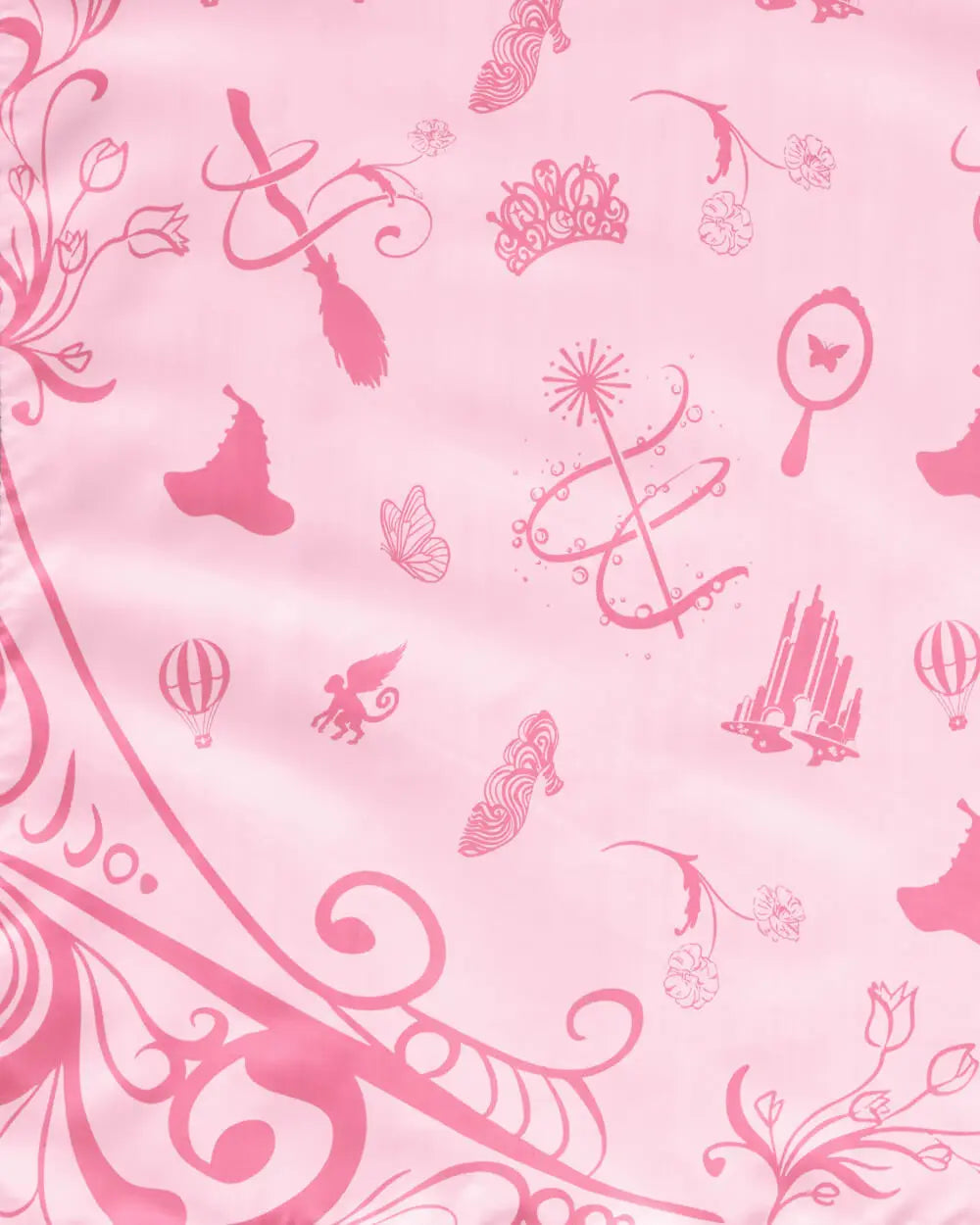 Wicked tablecloth pink Glinda side closeup showing crown wand butterfly mirror and Emerald City pattern details