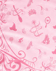 Wicked tablecloth pink Glinda side closeup showing crown wand butterfly mirror and Emerald City pattern details