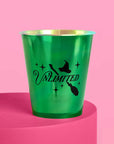 Wicked Unlimited green metallic party cup closeup showing witch hat broom and sparkle design on pink background