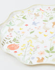 Close up of cream Meri Meri Little Animals cake plate with waved edge, watercolour bunnies, fox and wildflowers