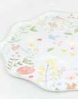 Close up of mint Meri Meri Little Animals party paper plate with waved edge, watercolour bunnies, fox and wildflowers