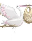 A jumbo foil balloon in the shape of a pink stork with 'It's a Girl' text, holding a gold balloon.